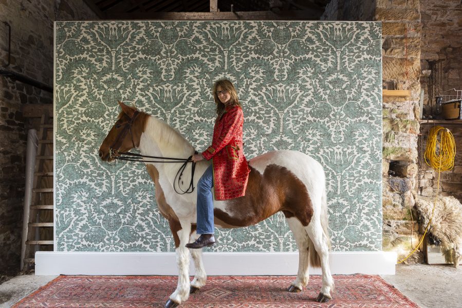 Totty Lowther on her horse with her Pomegranate wallpaper design for Lewis & Wood on Charis White Interiors blog